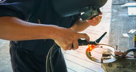 Engineers in the face welding mask with argon welding                          