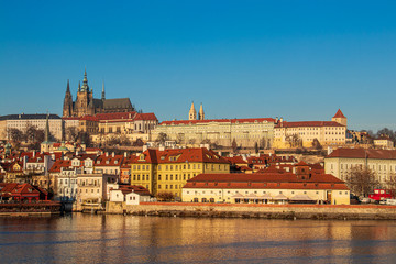 Fototapeta premium Sunlit Prague castle with buildings below