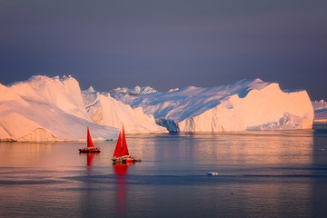 Greenland Ilulissat glaciers at ocean with res sailing boat © Jaro