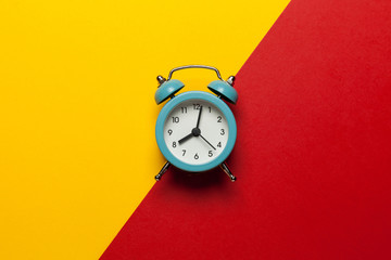 Hurry alarm clock on yellow background. 8:00 pm time, overtime work.