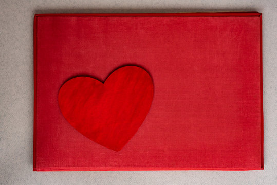 Valentines day heart on old red blanket background.