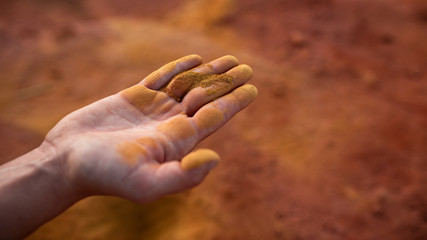 Ocher sand in a hand