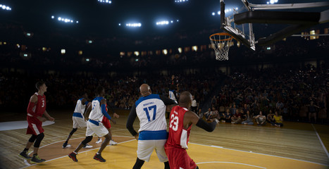 Obraz premium Basketball players on big professional arena during the game. Tense moment of the game.