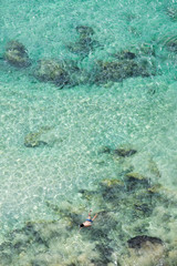 A person snorkeling in the turquoise waters of Fernando de Noronha