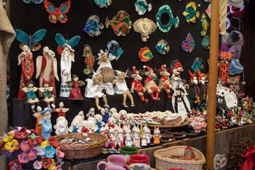 Handmade dolls and soft toys on the counter of the festive fair close-up.