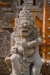 A traditional Balinese statue at the entrance to the gate of a Hindu temple in Central Ubud. Ubud Place. The most popular tourist destination in Ubud.