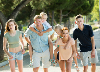 Adult parents with kids taking fast promenade © JackF