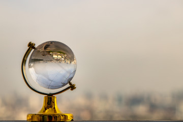 Looking through crystal globe showing an upside down skyline.