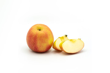 sliced yellow, ​red apples in front of white background
