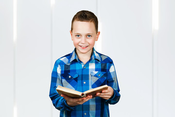 Boy holds books under his armpit. on white background