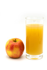 naturally cloudy apple juice - yellow, ​red apples with drops of water and a glass of naturally cloudy apple juice in front of white background