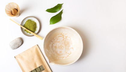 Fototapeta na wymiar White ceramic spoon with tea of a Matcha on a light gray background