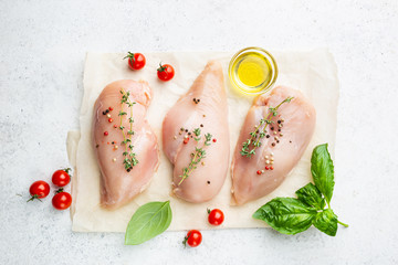 Fresh raw chicken breast with herbs and spices, top view. Culinary cooking ingredients