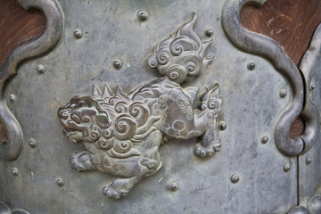 Ancient metal carving of an asian dragon