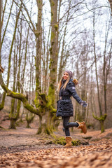 Fototapeta premium Young blonde girl dancing in a photo shoot in a beautiful forest