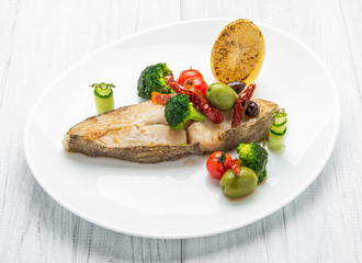 Fried halibut with vegetables and mustard, on the plate