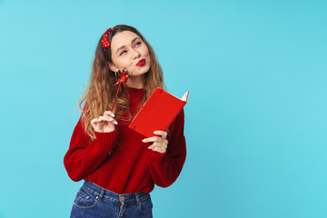 Image of dreaming blonde woman holding notebook and magic wand