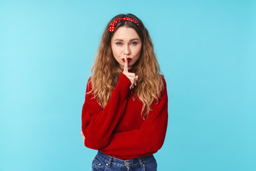 Image of beautiful young woman showing silence gesture
