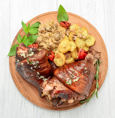 Roaster Pork Knuckle with savoy cabbage and baked potatoes