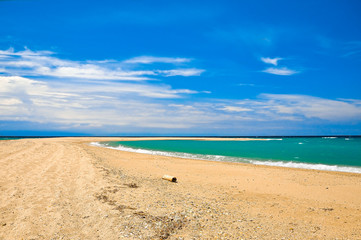 Sandy beach on the azure sea coast