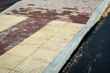 Paving slabs. Construction of a pedestrian road. New sidewalk in the city.