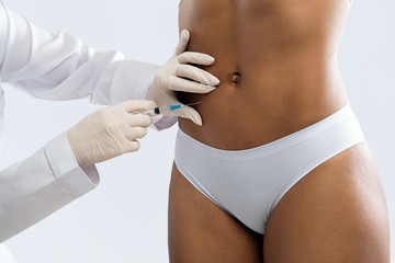 Close up of black woman having lipolysis treatment