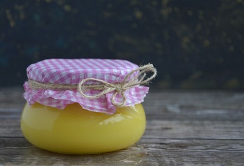 ghee oil in a jar on a wooden table