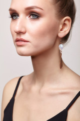 Fototapeta premium Beautiful woman with galvanic earring in form of maple seed