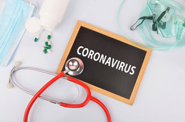 Text phrase Coronavirus on blackboard with medical equipment on white background. Novel coronavirus 2019-nCoV middle East respiratory syndrome coronavirus.