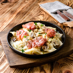 homemade dumplings with bacon in a pan