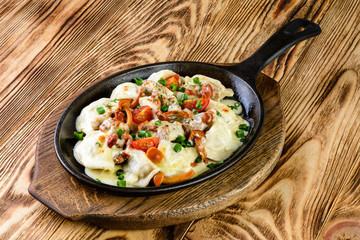 homemade dumplings with forest mushrooms in a pan