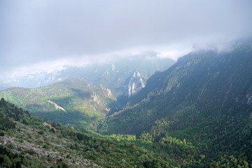 Fototapeta premium Fog revealing the mountain range, Ligurian Alps, northwestern Italy