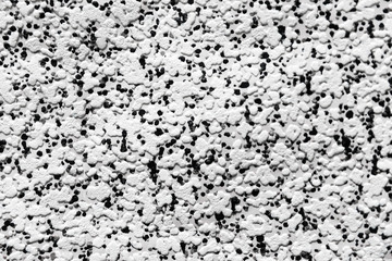 . A spot of different sizes is placed randomly. Useful for printing on fabric, interior decoration, home textile, wrapping paper, white embossed background with randomly scattered black dots, monochro