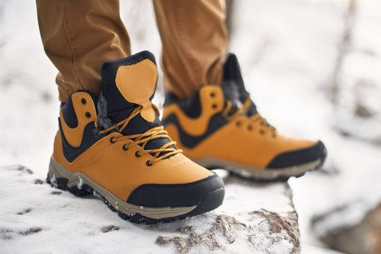 Hiking Or Trekking Shoes On Snow Close Up Shot. Technical Outdoor Boots Low Angle View. Mountaineering Or Climbing Winter Shoes Detailed Product Photo.