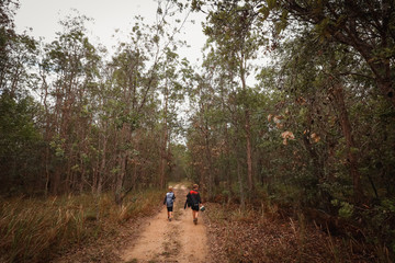 Two boys walking along country road
