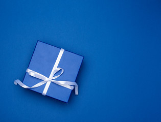 blue square box with a gift with a bow on a blue classic background