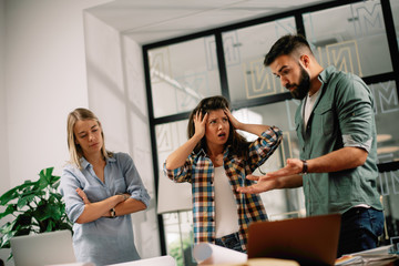 Fototapeta premium Colleagues arguing in office. Problem in team. Business people at meeting. 