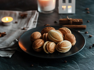 Cookies on a plate. Russian homemade cookies "Nuts". The cookie has the shape of a nut. Composition with candles and other romantic elements