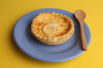 Delicious three cheese quiche in colored background