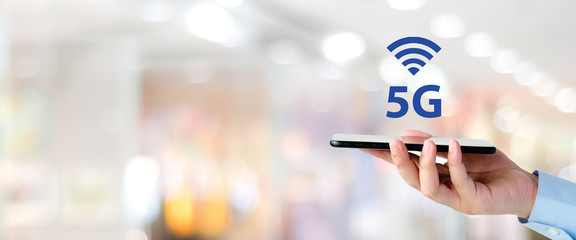 5G High speed internet network telecommunication, Man hand using mobile phone with 5G technology signal icon over blur background with copy space, Internet of things banner, template