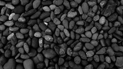 Fototapeta na wymiar black pebble beach stone background