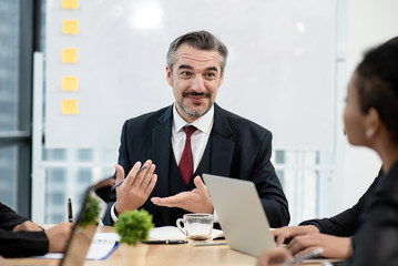 Caucasian boss was offering his opinion at a meeting with a beaming and positive countenance.