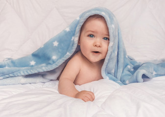Fototapeta na wymiar Sweet little blue eyes baby boy portrait with blue blanket on white background