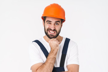 Young man builder in helmet posing isolated