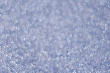 Obraz premium Abstract New Year blue bokeh background with shining defocus sparkles. Blurred glitters shimmering dust macro close up, copy space for text logo