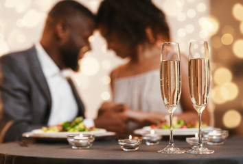 Glasses of champagne and candles on restaurant table