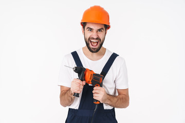 Man builder in helmet holding drill.