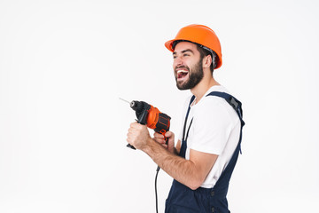 Man builder in helmet holding drill.