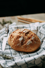  Cooking food with spices. A loaf of white rye bread. Sliced fresh bread on a towel.