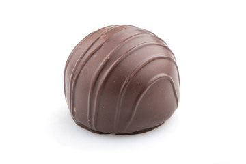 Single chocolate candy isolated on white background. side view.